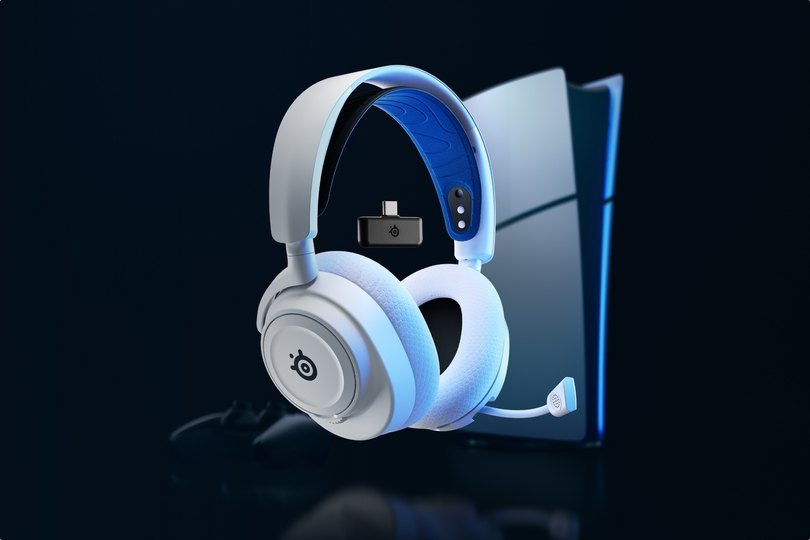 An Arctis Nova 7 laying against a desktop setup.