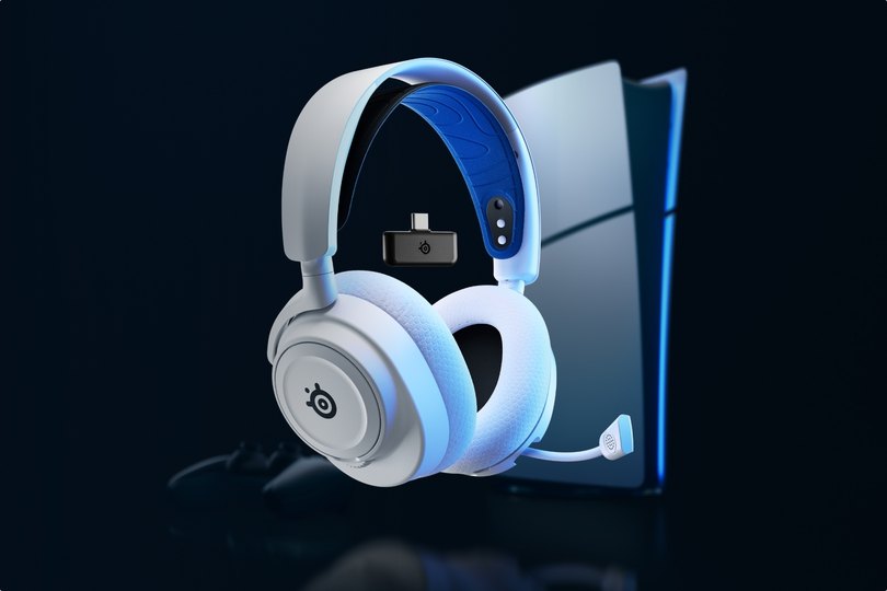 An Arctis Nova 7 laying against a desktop setup.